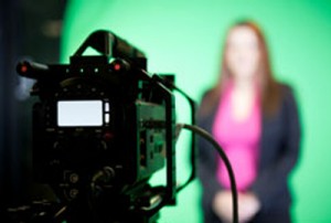 
Lady standing in front of a video camera.