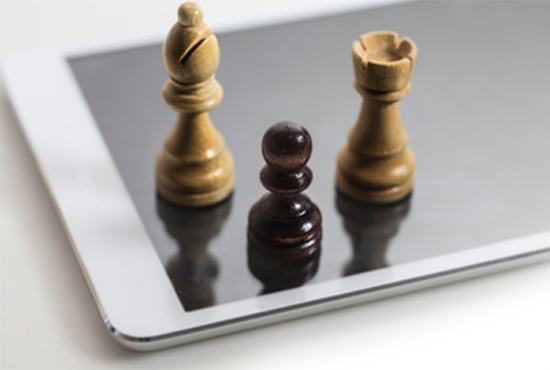 mobile app strategy depicted by tablet with chess pieces