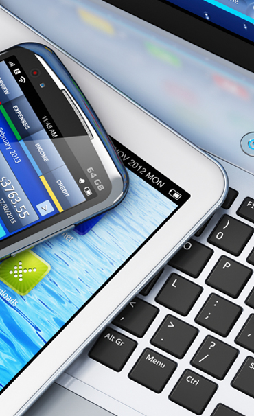 Picture of apps on smartphone and tablet, apps developed on laptop.
