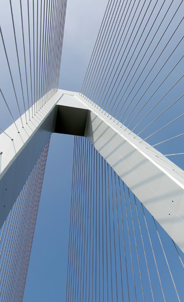 Picture looking up at the crest of a bridge.