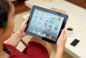 
Woman using an iPad over coffee.